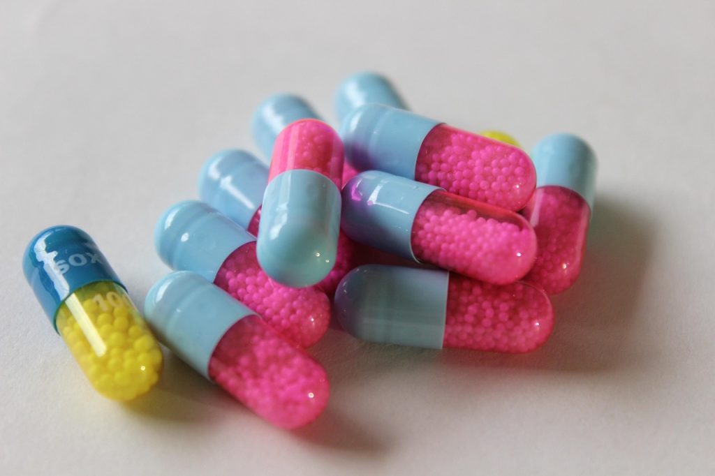 A scattered group of colourful capsules containing some pharma substance or other